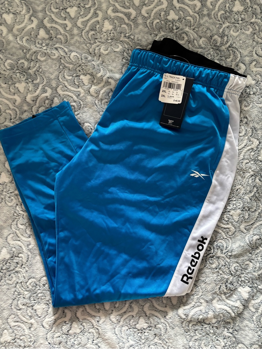 Reebok men’s size 2 XL track pants, bright blue, logo in stripe , BNWT